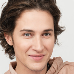 Joyful white young-adult male with medium  brown hair and brown eyes