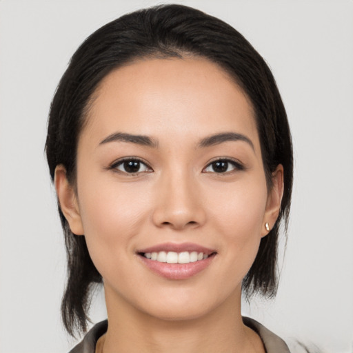 Joyful white young-adult female with medium  black hair and brown eyes