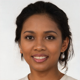 Joyful latino young-adult female with medium  brown hair and brown eyes