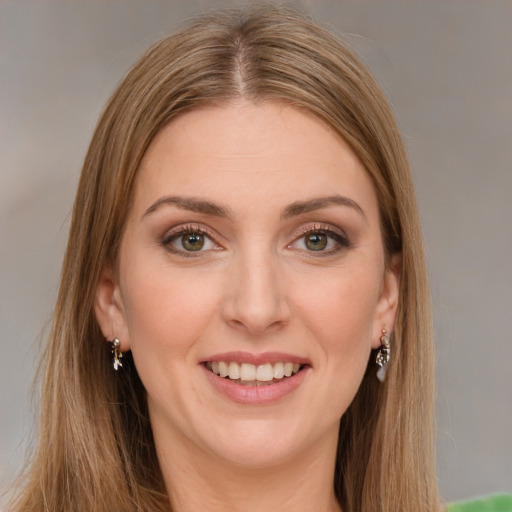 Joyful white young-adult female with long  brown hair and green eyes