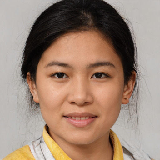 Joyful asian young-adult female with medium  brown hair and brown eyes