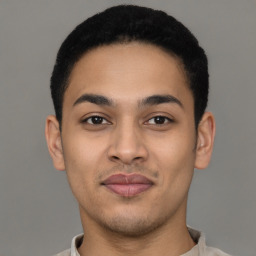 Joyful latino young-adult male with short  brown hair and brown eyes