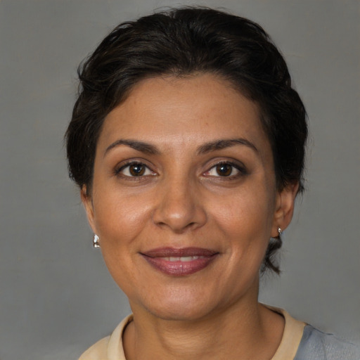 Joyful white adult female with short  brown hair and brown eyes