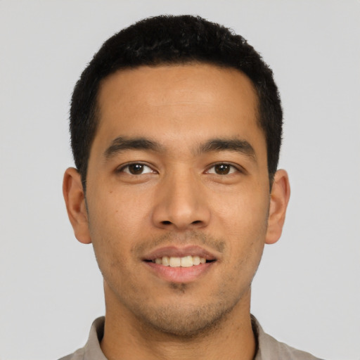 Joyful latino young-adult male with short  black hair and brown eyes