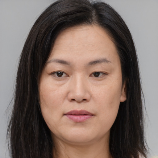 Joyful asian young-adult female with long  brown hair and brown eyes
