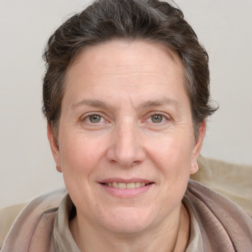 Joyful white adult female with medium  brown hair and grey eyes