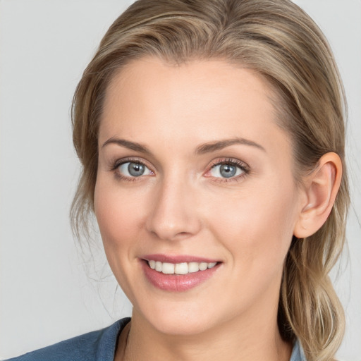 Joyful white young-adult female with medium  brown hair and blue eyes