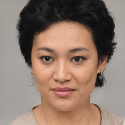 Joyful asian young-adult female with medium  black hair and brown eyes