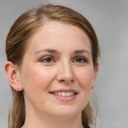 Joyful white young-adult female with medium  brown hair and grey eyes