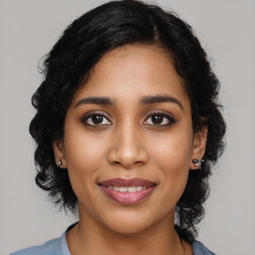 Joyful latino young-adult female with medium  black hair and brown eyes