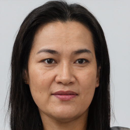 Joyful asian adult female with long  brown hair and brown eyes