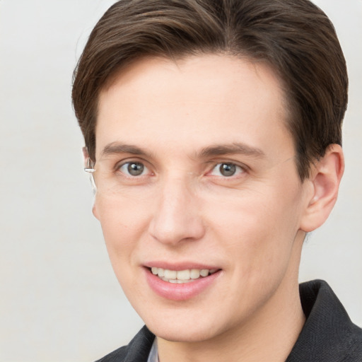 Joyful white young-adult female with short  brown hair and grey eyes