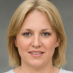 Joyful white young-adult female with medium  brown hair and green eyes