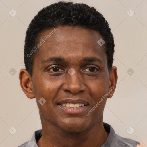 Joyful black young-adult male with short  black hair and brown eyes