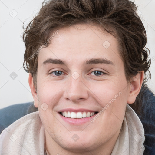 Joyful white young-adult female with short  brown hair and blue eyes