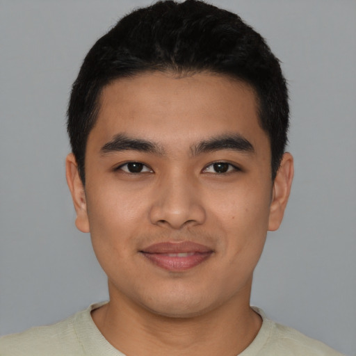Joyful latino young-adult male with short  black hair and brown eyes