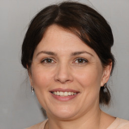 Joyful white adult female with medium  brown hair and brown eyes