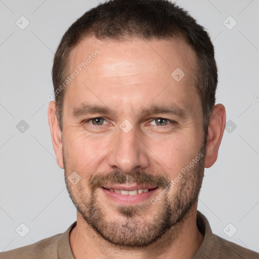 Joyful white adult male with short  brown hair and brown eyes