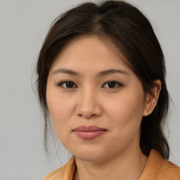 Joyful asian young-adult female with medium  brown hair and brown eyes