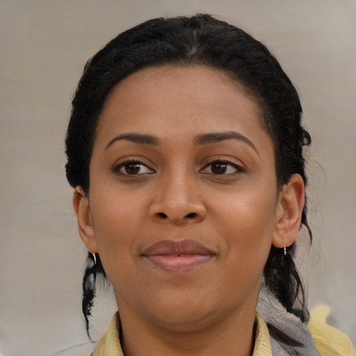 Joyful black young-adult female with medium  brown hair and brown eyes