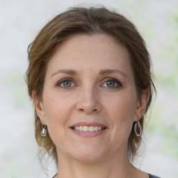 Joyful white adult female with medium  brown hair and grey eyes