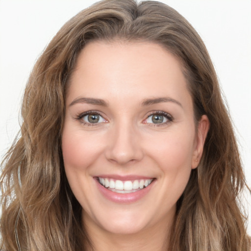 Joyful white young-adult female with long  brown hair and green eyes