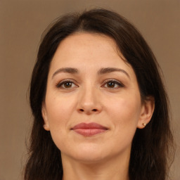 Joyful white adult female with long  brown hair and brown eyes