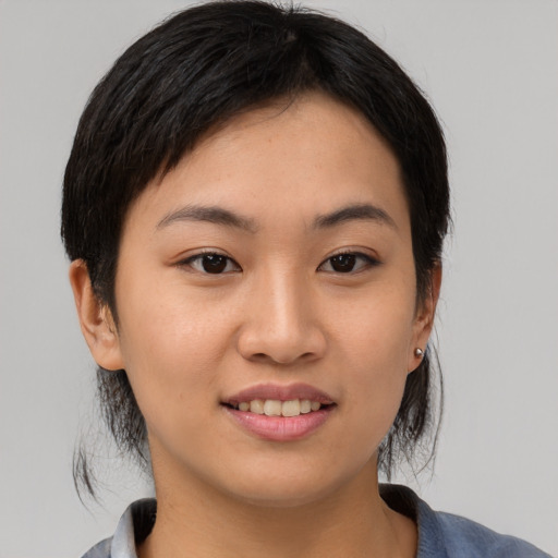 Joyful asian young-adult female with medium  brown hair and brown eyes