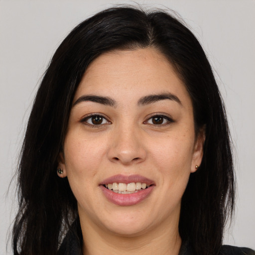 Joyful latino young-adult female with long  black hair and brown eyes