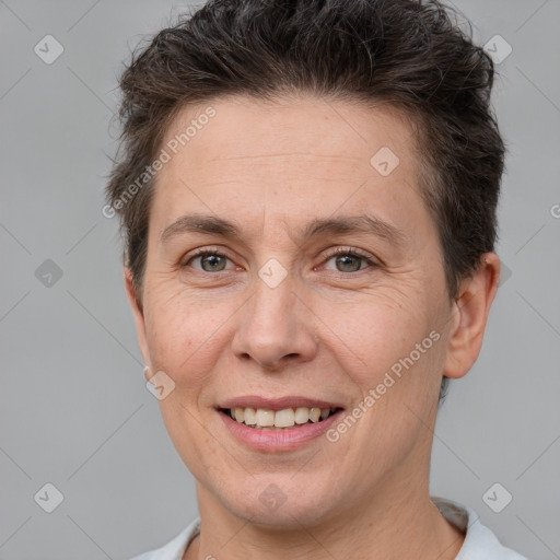 Joyful white adult female with short  brown hair and brown eyes