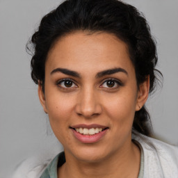 Joyful white young-adult female with medium  black hair and brown eyes