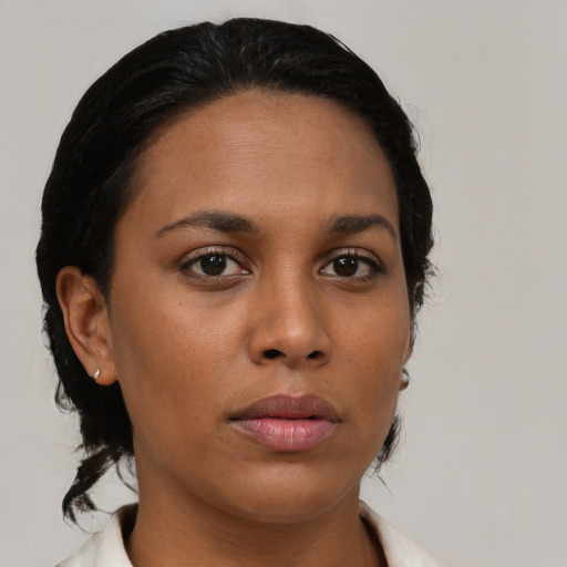 Joyful black young-adult female with medium  brown hair and brown eyes