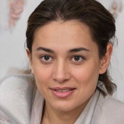 Joyful white young-adult female with medium  brown hair and brown eyes