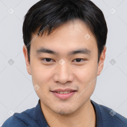 Joyful asian young-adult male with short  black hair and brown eyes