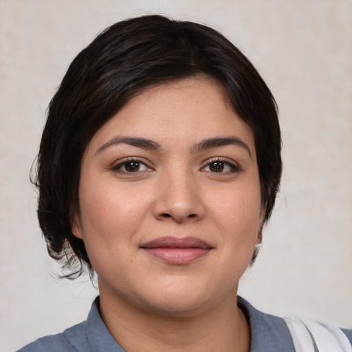 Joyful white young-adult female with medium  black hair and brown eyes