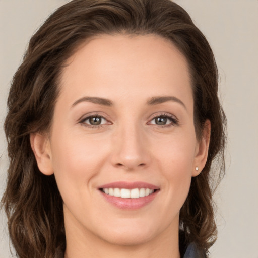 Joyful white young-adult female with medium  brown hair and green eyes