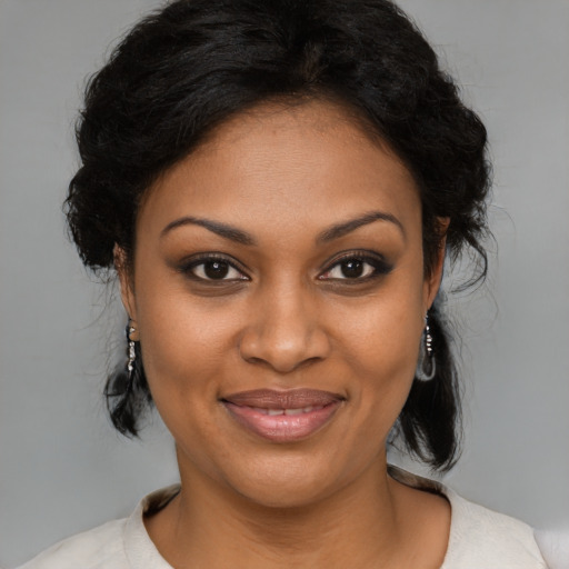 Joyful black young-adult female with medium  brown hair and brown eyes