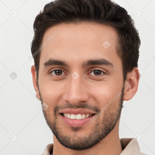 Joyful white young-adult male with short  brown hair and brown eyes