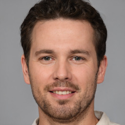 Joyful white adult male with short  brown hair and brown eyes