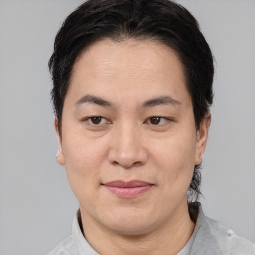 Joyful asian adult female with short  brown hair and brown eyes