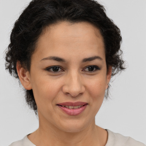 Joyful latino adult female with short  brown hair and brown eyes