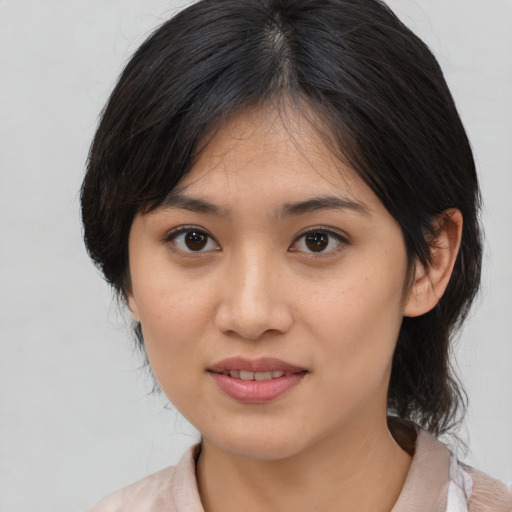 Joyful asian young-adult female with medium  brown hair and brown eyes