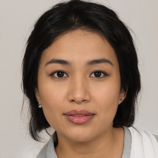 Joyful asian young-adult female with medium  black hair and brown eyes