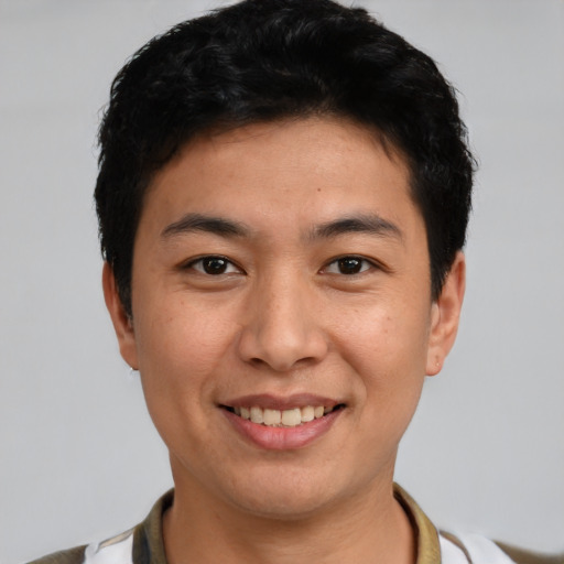 Joyful white young-adult male with short  black hair and brown eyes