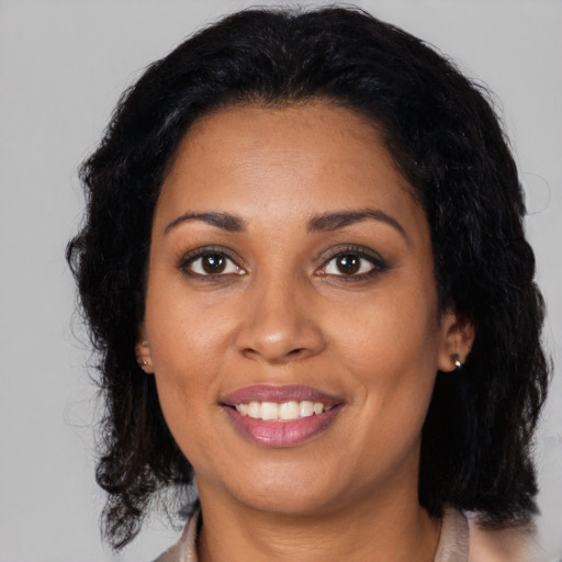 Joyful black adult female with medium  black hair and brown eyes