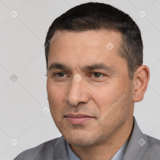 Joyful white adult male with short  black hair and brown eyes