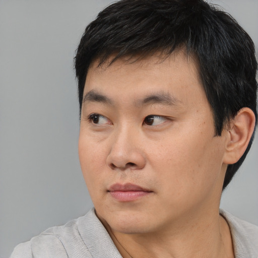 Neutral asian young-adult male with short  black hair and brown eyes