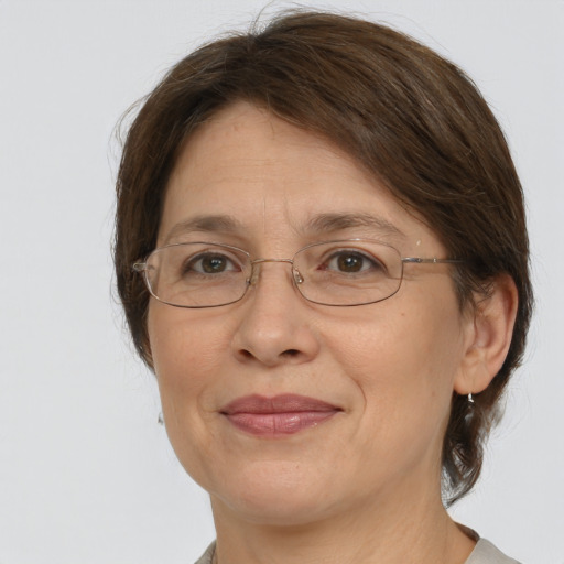 Joyful white adult female with medium  brown hair and grey eyes