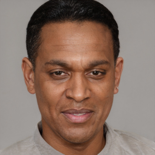 Joyful black adult male with short  brown hair and brown eyes