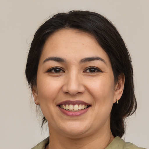 Joyful asian young-adult female with medium  brown hair and brown eyes